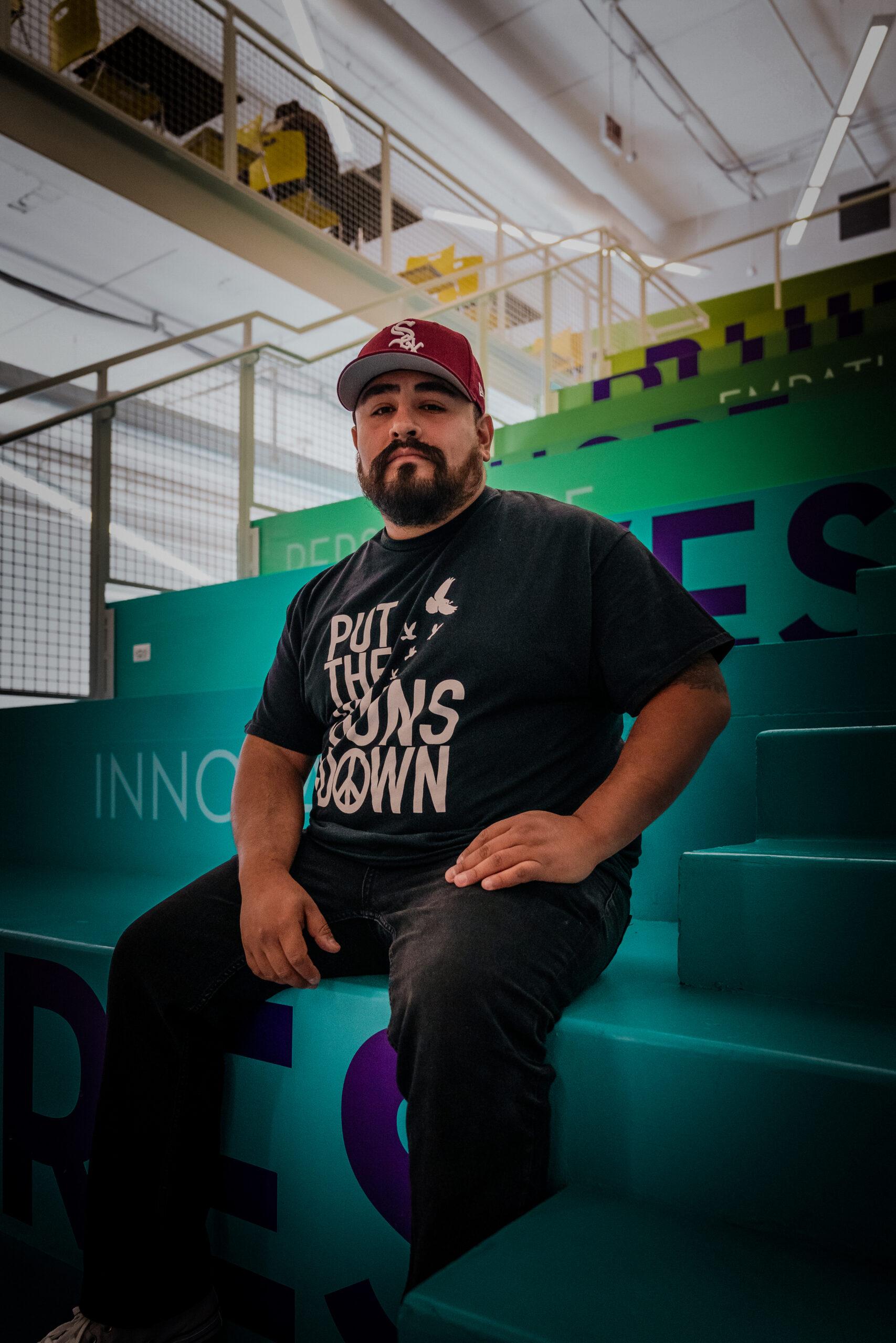 Pablo Galvez sits on the stairs at BUILD Chicago